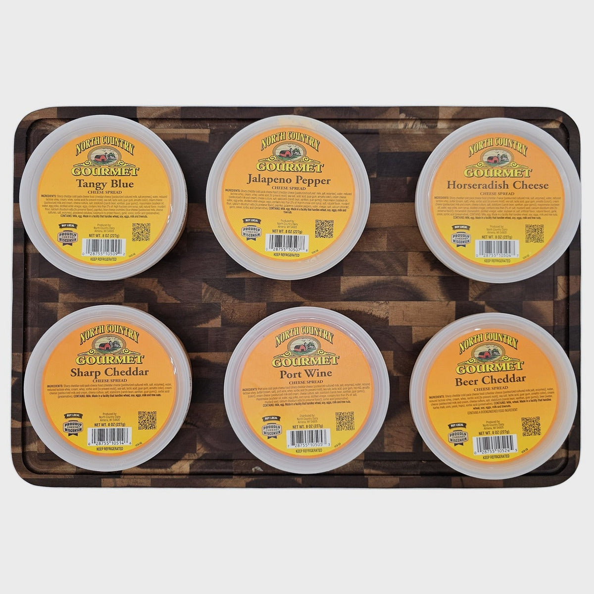 Six North Country cheese spreads on a cutting board
